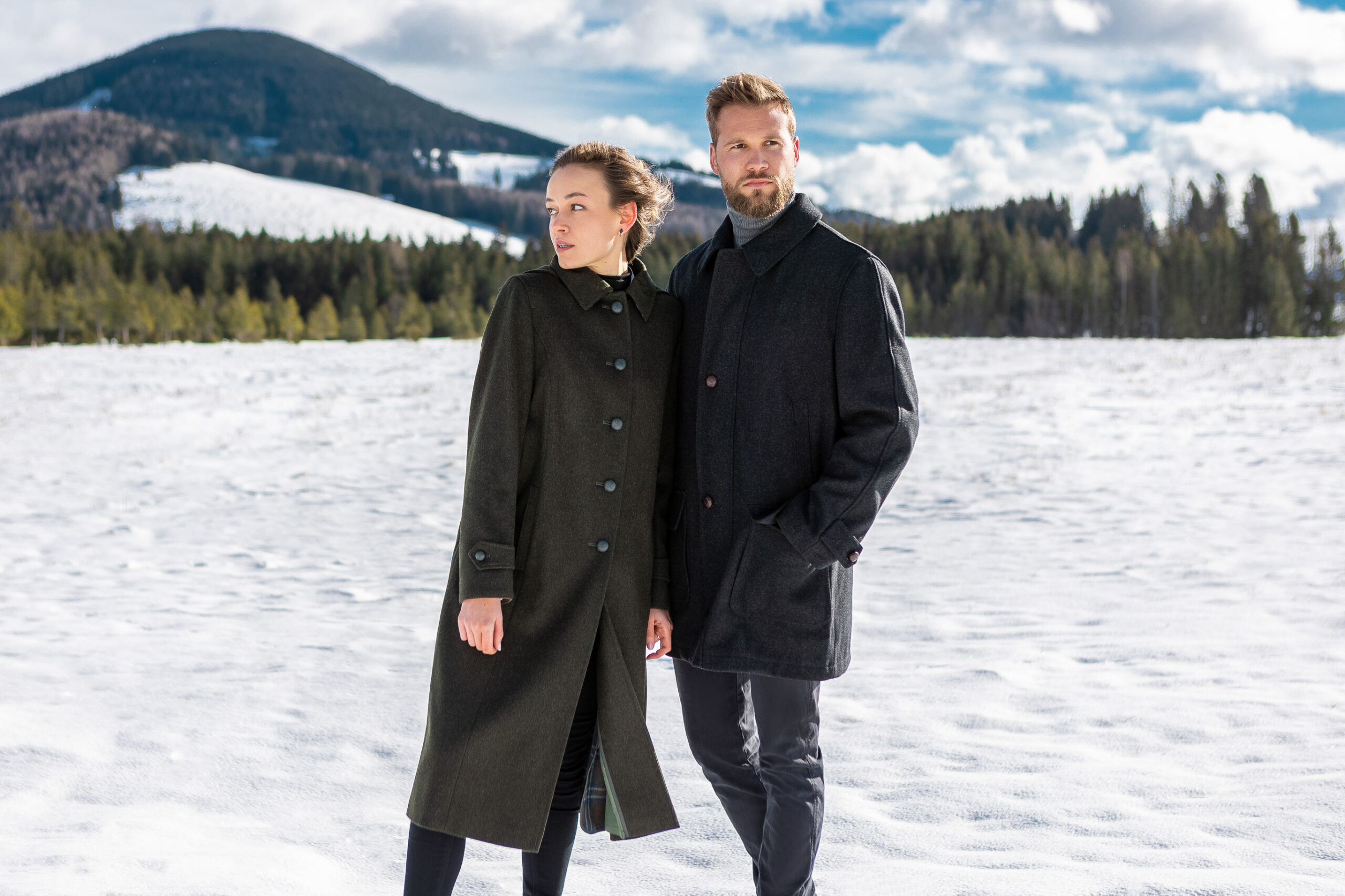 Young woman and young man wearing loden coats